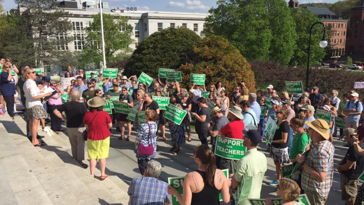 VT-NEA members stand on the statehouse steps for a rally.