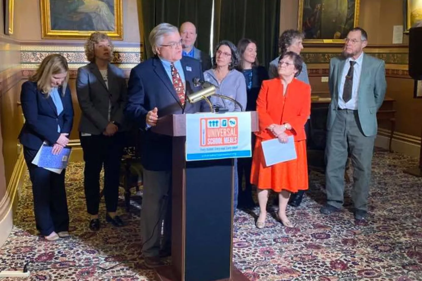 VT-NEA President Don Tinney speaks into a microphone.