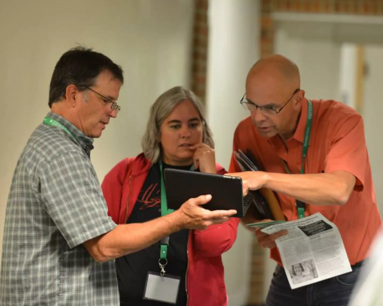 VT-NEA members look over a tablet together.