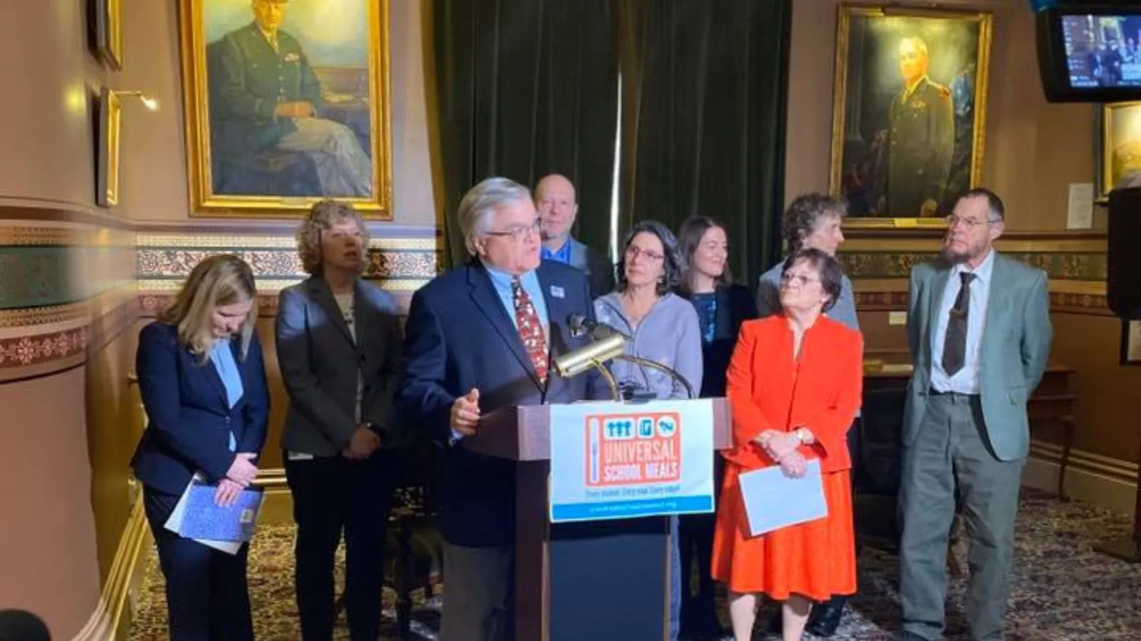 VT-NEA President Don Tinney speaks into a microphone.