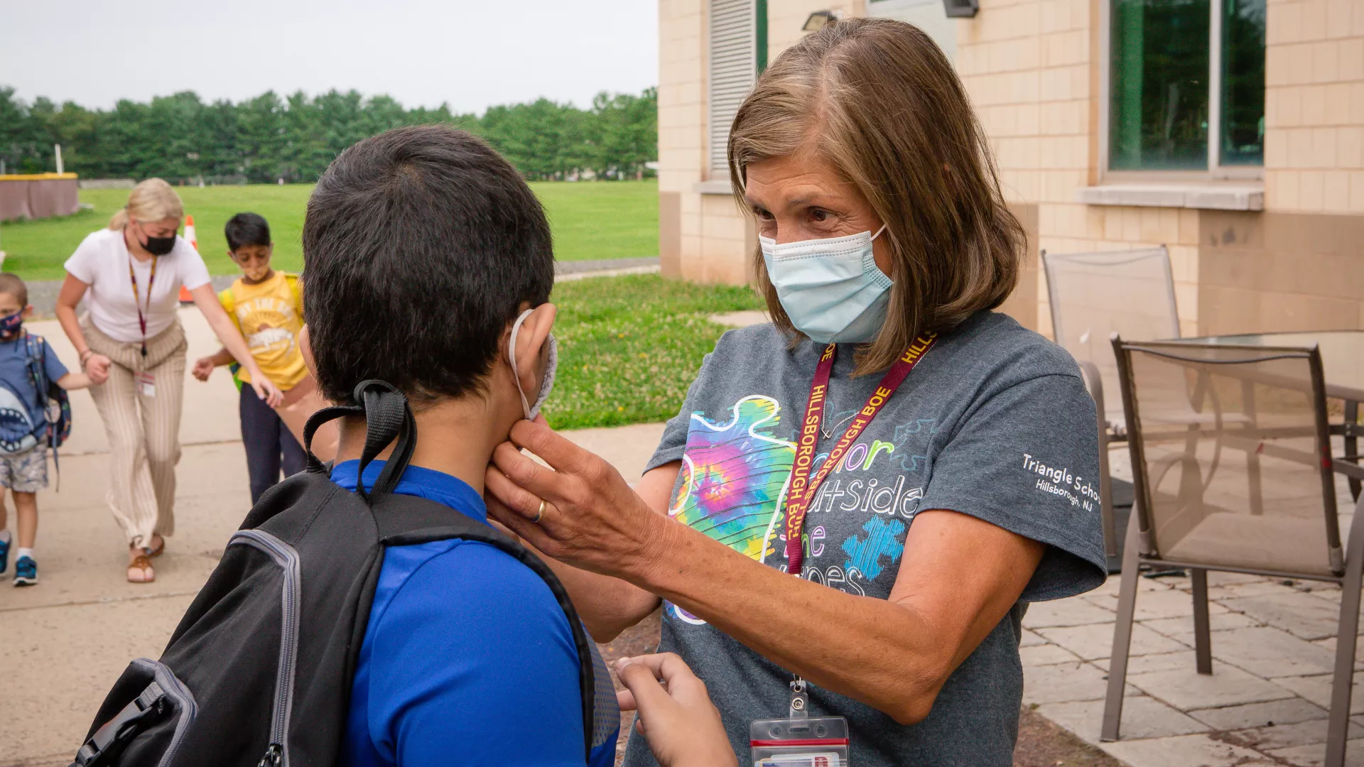 ESP helping student with their mask