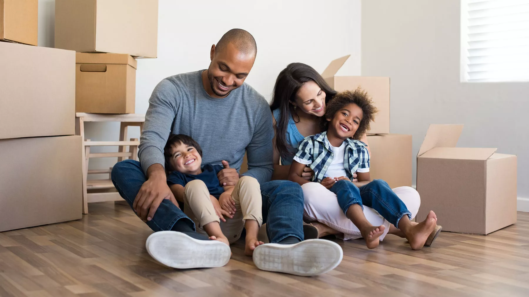 Family with moving boxes - affordable housing
