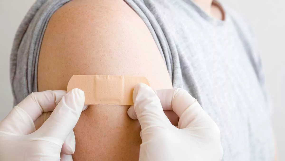 Nurse applies a bandage to a child's arm