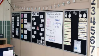 photo of Alison Tingle's anchor boards with black backgrounds and white paper squares with hand-written information